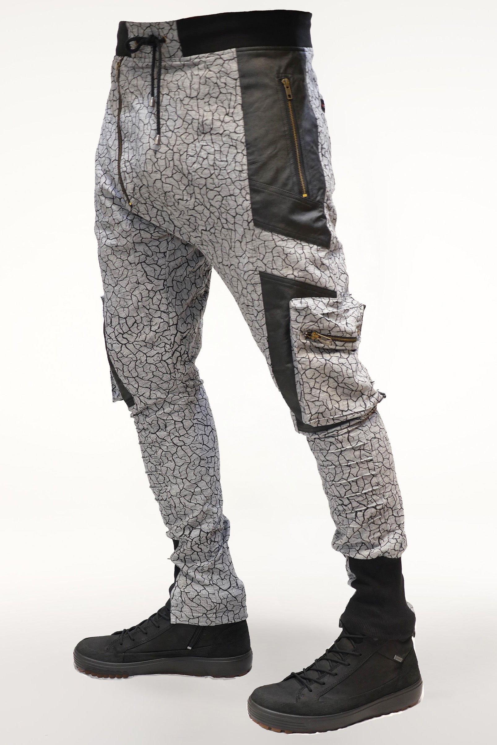 Brass zipper hardware detail on men’s cracked earth printed cotton pants