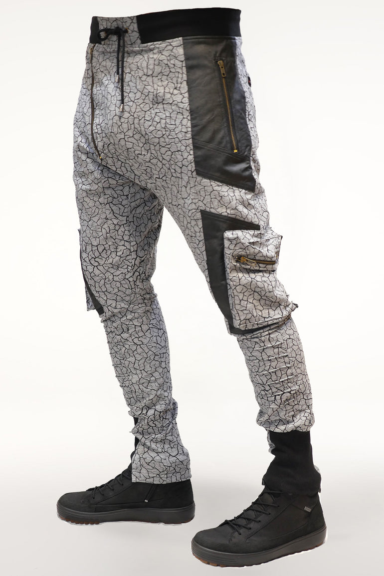 Brass zipper hardware detail on men’s cracked earth printed cotton pants